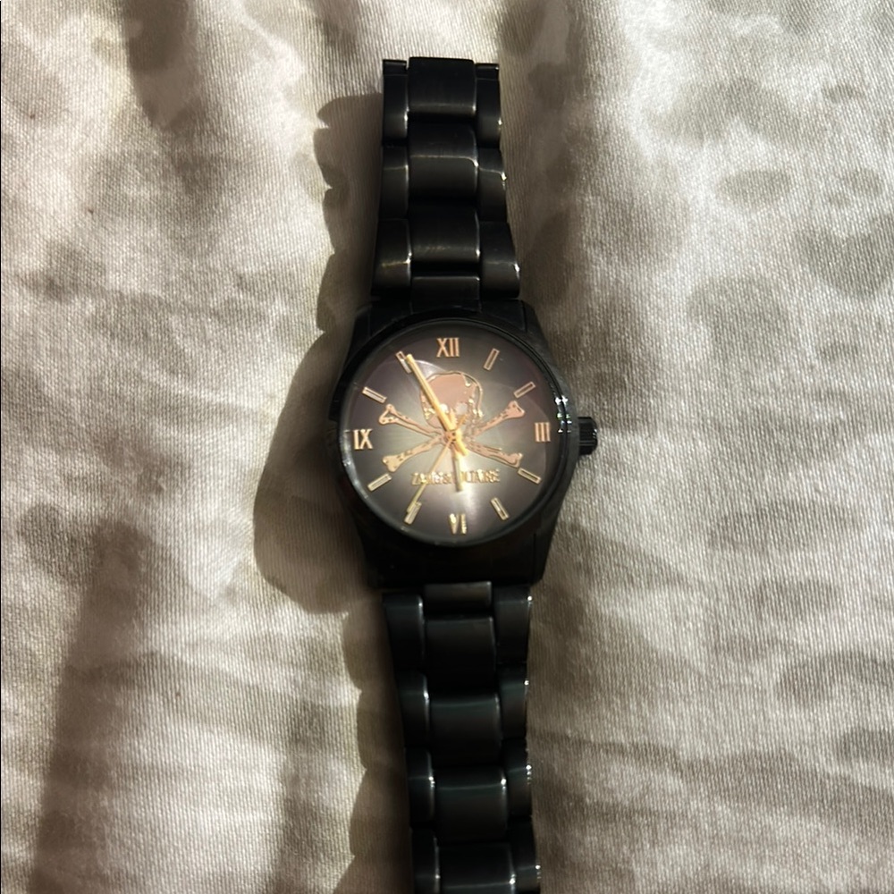 Zadig and Voltaire watch with gold skull and crossbones.